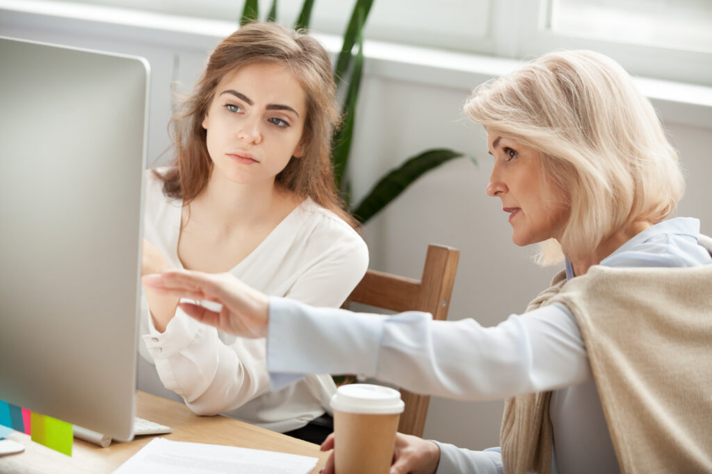 senior employee teaching new marketing grad