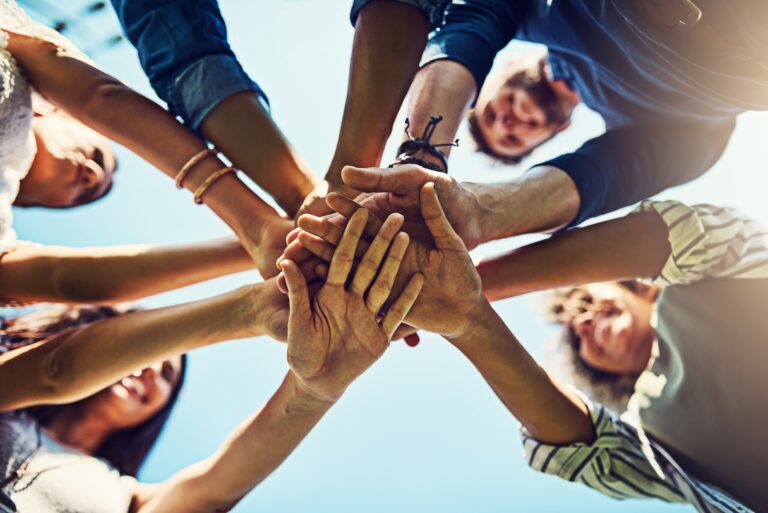positive team gathering hands