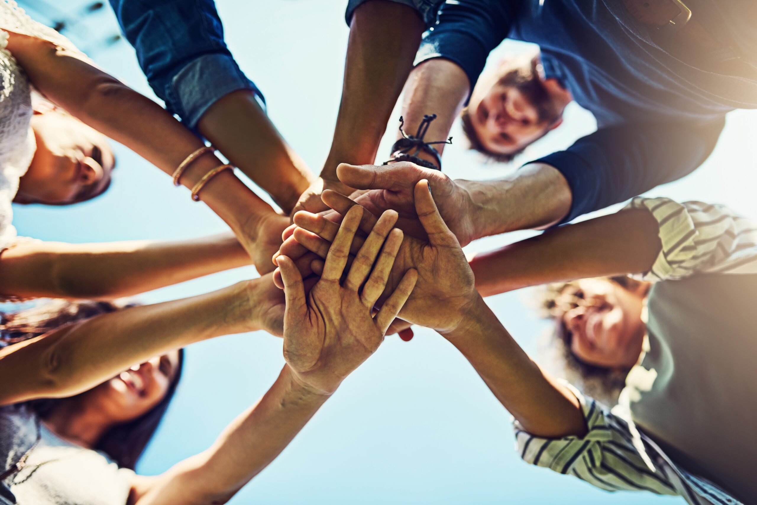positive team gathering hands